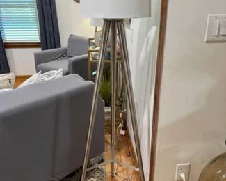 Silver tone metal tripod floor lamp