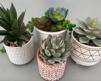 Many lots of faux plants in varying sizes and shapes of planters