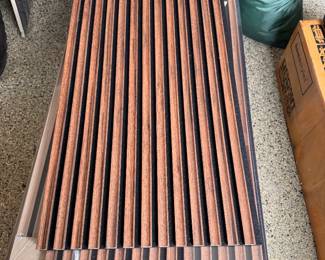 Light Walnut Finish Wood Slat Acoustic Wall Panels. Each Measures 12" W x 106" L.
