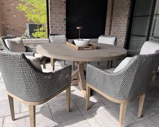 Concrete Top Dining with Oak Pedestal Base. Table Measures 60" D with 29” Clearance. Set of 6 Wall Weather Woven Dining Chairs. Photo 1 of 5.