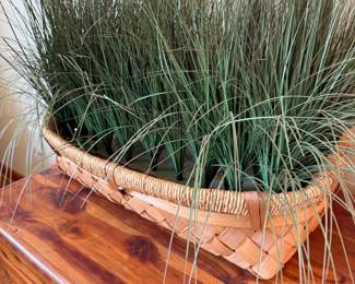 Woven basket with faux grass decorative arrangement