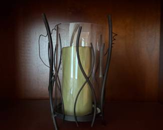 Glass hurricane candle holder with twisted metal wire frame