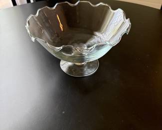Clear glass footed compote bowl with ruffled scalloped rim