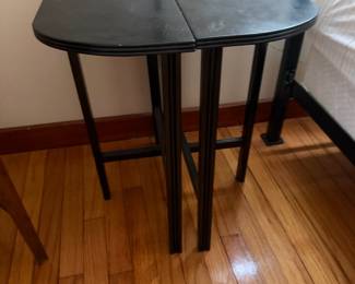 Pair of black wood nesting tables with oval tops