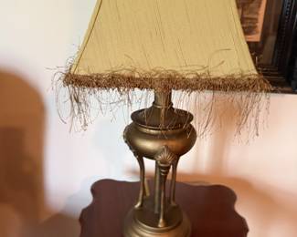 Brass tripod table lamp with fringed silk shade