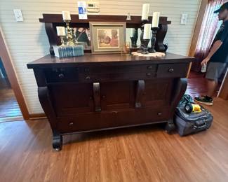 Antique carved wood sideboard with mirrored back and scroll feet