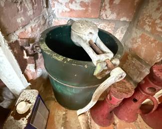 Vintage green metal bucket with cast iron hand pump