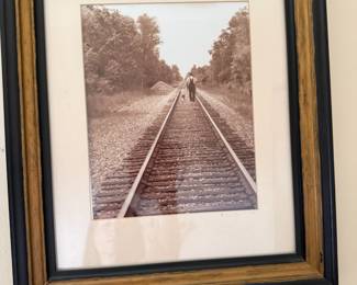 Sepia toned railroad tracks photograph with father and child in frame