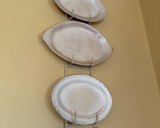 Scrolled metal wall rack with three ceramic serving platters