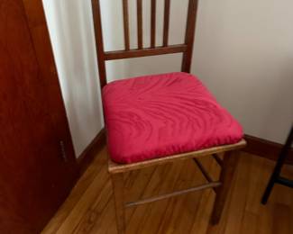 Wooden slat-back side chair with red cushioned seat