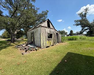 Weathered wood shed, collapsing, in rural yard