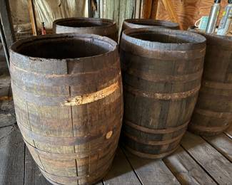 Wooden whiskey barrels with metal bands, set of four