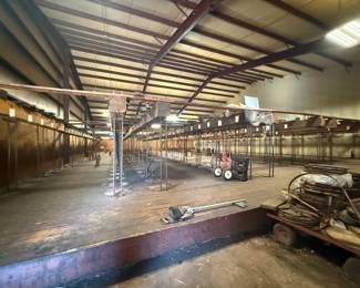 Warehouse interior with industrial shelving and metal cart carts