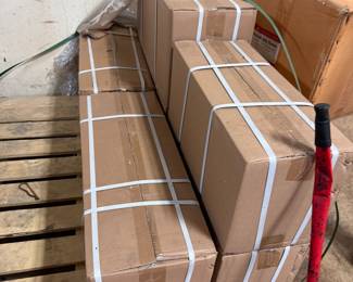 Strapped cardboard boxes on wooden pallet, garage stock