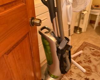 Upright bagless vacuum with hose attachment and standing oscillating fan
