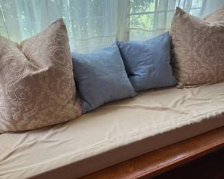 Window seat cushion with damask and suede throw pillows