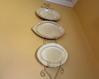 Scrolled metal wall plate rack with three ceramic platters