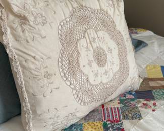 Cream embroidered pillow with crochet lace medallion center