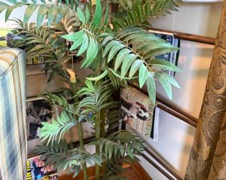 Artificial palm tree in black plastic planter