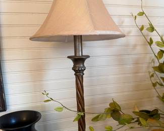Twisted metal candlestick table lamp with bell-shaped fabric shade