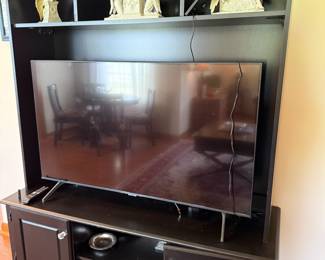 Black wood entertainment center with cabinet storage and open shelving