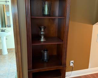 Tall wood bookcase with carved trim and adjustable shelves