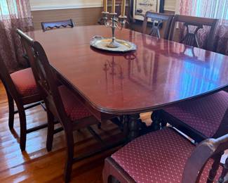 Mahogany dining table with six upholstered chairs