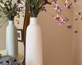 White ceramic bottle vases with faux purple flower stems, pair