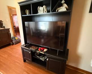 Black wood entertainment center with hutch and cabinet storage