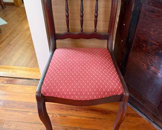 Mahogany spindle-back dining chair with red diamond upholstered seat