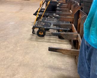 Row of wooden and mesh garden wagon carts on wheels