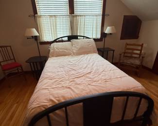 Bedroom view with wood spindle bed and side chairs