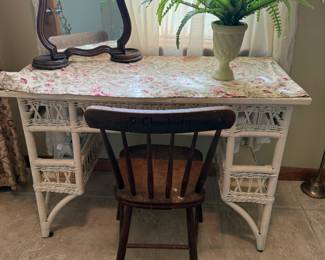 White wicker vanity desk with wood-framed swivel mirror