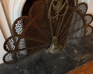 Antique brass fan-shaped fireplace screen with pierced petal design