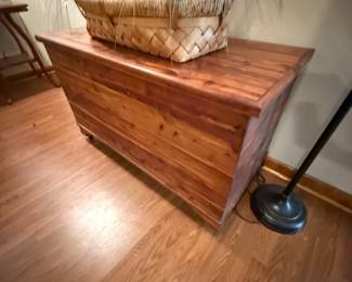 Cedar wood blanket chest with woven basket and faux grass on top