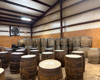 Warehouse full of large wooden whiskey barrels