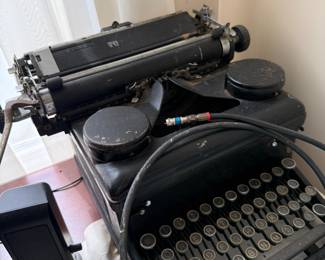 Vintage black metal manual typewriter with round glass keys