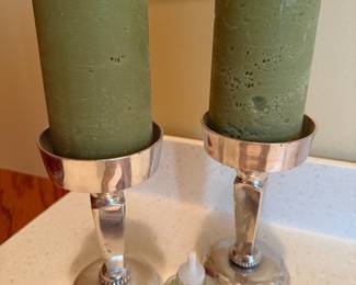 Silver plate pillar candlesticks with green candles, pair