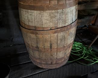 Wooden barrel with rusted metal bands, primitive style