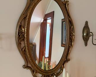 Ornate gold gilt oval mirror with floral carved frame
