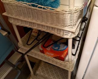 White wicker three-tier laundry room shelving cart