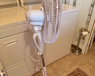 White adjustable oscillating pedestal fan on tripod base