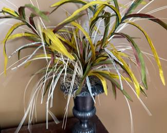 Faux grass floral arrangement in pedestal urn
