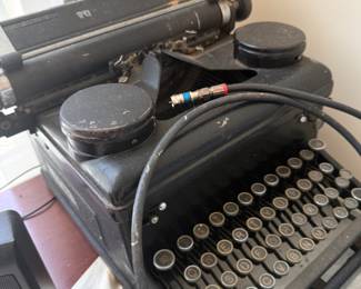 Vintage black metal manual typewriter with round glass keys