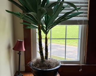Artificial palm plant in decorative ceramic planter