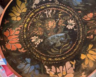 vintage Mexican folk art hand-painted wooden bowl or decorative tray, featuring traditional floral lacquer work or gouache painted motifs. This specific style of folk art is highly characteristic of historical lacquerware regions in Mexico, such as Olinalá (Guerrero) or Uruapan (Michoacán), which are celebrated for their hand-carved wooden vessels finished with dark backgrounds and vibrant, multi-colored floral borders.