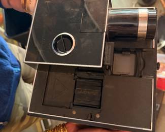 This item is a vintage Bell & Howell Slide Cube 35mm slide projector, widely produced throughout the 1970s