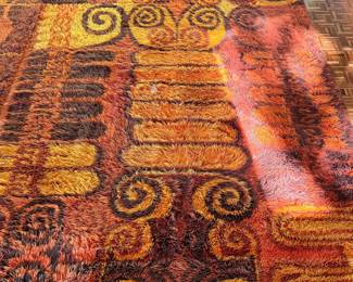 highly collectible vintage 1960s–1970s Scandinavian Rya shag rug. This specific, iconic mid-century modern design features bold, impressionistic scroll and block motifs in a classic "space age" palette of vibrant fiery orange, golden yellow, rust, and deep chocolate brown