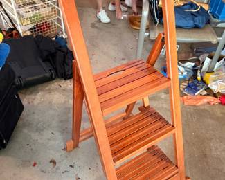 This is a wooden folding library/step chair—a clever convertible design that functions as a chair and folds into a small step ladder. These are sometimes called Franklin chairs, library chairs, or metamorphic step chairs.