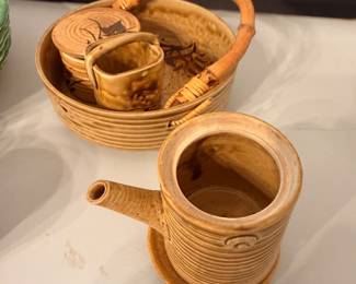 vintage mid-century Japanese Otagiri-style ribbed stoneware sake or tea set, featuring a beautifully glazed tan body with prominent horizontal ribbing (known as a "hori" pattern), painted grass/bamboo motif accents, and an integrated bent bamboo overhead handle